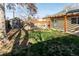 Lush backyard with a shed and wood pergola perfect for relaxing in shaded comfort at 4595 S Lincoln St, Englewood, CO 80113