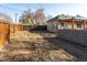 Wide backyard featuring wooden fence, concrete block structure, and pergola creating a canvas for outdoor living at 4595 S Lincoln St, Englewood, CO 80113