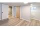 A finished basement with wood-look flooring and access to a crawl space and utility room at 4595 S Lincoln St, Englewood, CO 80113