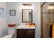 Well-lit bathroom with modern vanity, tile shower, and a soft color palette at 4595 S Lincoln St, Englewood, CO 80113
