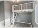 Bedroom featuring a loft bed with ladder and access to natural light at 4595 S Lincoln St, Englewood, CO 80113