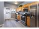 Well-lit kitchen with stainless steel appliances, granite counters, and plenty of storage at 4595 S Lincoln St, Englewood, CO 80113