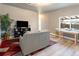 Comfortable living room with a large TV, a decorative house plant, and warm natural lighting at 4595 S Lincoln St, Englewood, CO 80113