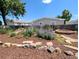 Landscaped backyard with beautiful flower garden, rock border and a fire pit at 2032 Tulane St, Denver, CO 80260