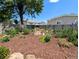 Landscaped backyard with beautiful flower garden, rock border and mulch at 2032 Tulane St, Denver, CO 80260