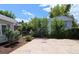 Fenced backyard featuring a concrete pad and mature trees at 2032 Tulane St, Denver, CO 80260