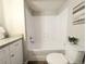 Clean bathroom features a shower and tub with white tile and wood flooring at 2032 Tulane St, Denver, CO 80260