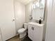 A cozy bathroom with a single vanity and mirror, a toilet, and modern fixtures at 2032 Tulane St, Denver, CO 80260