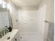 Bathroom showcasing a white shower stall with built-in shelving and a modern sink vanity at 2032 Tulane St, Denver, CO 80260