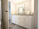 Bathroom with white vanity, granite countertop, decorative light fixture, and gray scale rug at 2032 Tulane St, Denver, CO 80260