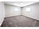 Spacious bedroom with gray carpet and two bright windows offering natural light at 2032 Tulane St, Denver, CO 80260