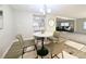 Open dining area with modern lighting, wood-look floors, and access to the kitchen and living room at 2032 Tulane St, Denver, CO 80260