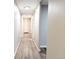 Long hallway with light wood floors, neutral paint, and recessed lighting at 2032 Tulane St, Denver, CO 80260