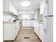 Efficient kitchen featuring white cabinetry, and ample counter space at 2032 Tulane St, Denver, CO 80260