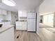 Kitchen area with white appliances, granite countertops, and an open flow to the living area at 2032 Tulane St, Denver, CO 80260