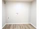Empty laundry room with wood floors, ready for customization at 2032 Tulane St, Denver, CO 80260