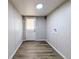 Clean laundry room with wood flooring and access to the outside at 2032 Tulane St, Denver, CO 80260