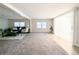 Spacious living room with abundant natural light and seamless flow to the adjacent dining area at 2032 Tulane St, Denver, CO 80260