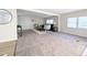 Open-concept living room with fresh paint, carpet, and bright windows offering plenty of sunlight at 2032 Tulane St, Denver, CO 80260