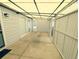 View of covered patio and entry with bright lighting and slider door to the house at 2032 Tulane St, Denver, CO 80260