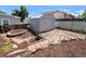 Well-kept shed in a fenced backyard featuring landscaping with decorative stone at 2032 Tulane St, Denver, CO 80260