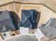 Aerial view of a house featuring a dark roof, a driveway and surrounding homes in the neighborhood at 3884 Freestone Pt, Castle Rock, CO 80108
