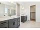 Bright bathroom featuring double sinks, modern fixtures, and walk-in shower, with contemporary design at 3884 Freestone Pt, Castle Rock, CO 80108