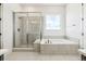 Modern bathroom features a glass enclosed shower and a soaking tub at 3884 Freestone Pt, Castle Rock, CO 80108