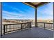 Relaxing covered deck with wood railings, offering scenic neighborhood views at 3884 Freestone Pt, Castle Rock, CO 80108