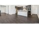 Modern kitchen features stainless steel appliances, a center island, dark cabinets, and hardwood floors at 3884 Freestone Pt, Castle Rock, CO 80108