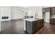 Open concept kitchen features a center island with modern finishes, stainless appliances, and dark cabinets at 3884 Freestone Pt, Castle Rock, CO 80108