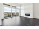 Bright living room features large windows, a fireplace, and dark hardwood floors with an open, airy feel at 3884 Freestone Pt, Castle Rock, CO 80108