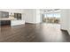 Open-concept living space with dark hardwood floors and ample natural light at 3884 Freestone Pt, Castle Rock, CO 80108