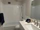 Bright bathroom featuring a shower-over-tub combination and sleek white countertop with modern faucet at 635 S Alton Way # 1C, Denver, CO 80247