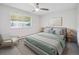 Serene bedroom with a ceiling fan and plush neutral bedding at 635 S Alton Way # 1C, Denver, CO 80247