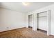 Bedroom with double door closet and carpet at 635 S Alton Way # 1C, Denver, CO 80247