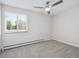 This is a bedroom with neutral carpet, white walls, ceiling fan, and window with natural light at 635 S Alton Way # 1C, Denver, CO 80247