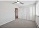 This is a bedroom with neutral carpet, white walls, ceiling fan, and closet with white doors at 635 S Alton Way # 1C, Denver, CO 80247