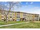 The building at 635 S Alton Way with holiday decorations, lawn, and clear blue skies at 635 S Alton Way # 1C, Denver, CO 80247