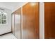 Hallway with storage lockers, tiled flooring, and window for natural light, offering practicality and convenience at 635 S Alton Way # 1C, Denver, CO 80247