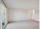 Spacious carpeted living room with sliding glass door at 635 S Alton Way # 1C, Denver, CO 80247