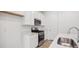 Modern kitchen with white cabinets, stainless steel appliances, and a sleek sink at 1362 Rock Cliff Ave, Erie, CO 80516