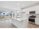 Bright kitchen with white cabinets, a center island, and stainless steel appliances at 1362 Rock Cliff Ave, Erie, CO 80516
