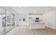 Bright kitchen with white cabinets, a center island, and sliding glass doors at 1362 Rock Cliff Ave, Erie, CO 80516