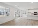 Open-concept living room and kitchen area, with a fireplace and sliding glass doors at 1362 Rock Cliff Ave, Erie, CO 80516