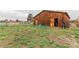 Exterior of wooden barn with open doors on a spacious lot at 1341 Tomichi Dr, Franktown, CO 80116