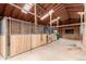 View of barn interior featuring skylights, stalls, and ample storage at 1341 Tomichi Dr, Franktown, CO 80116