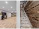 Spacious basement with carpeted stairs, wood accent wall and luxury vinyl flooring throughout at 1341 Tomichi Dr, Franktown, CO 80116