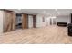 Expansive basement featuring luxury vinyl flooring and sliding barn doors creating flexible living spaces at 1341 Tomichi Dr, Franktown, CO 80116