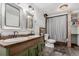 This rustic bathroom offers wood accents, double sinks, and a shower with curtain at 1341 Tomichi Dr, Franktown, CO 80116